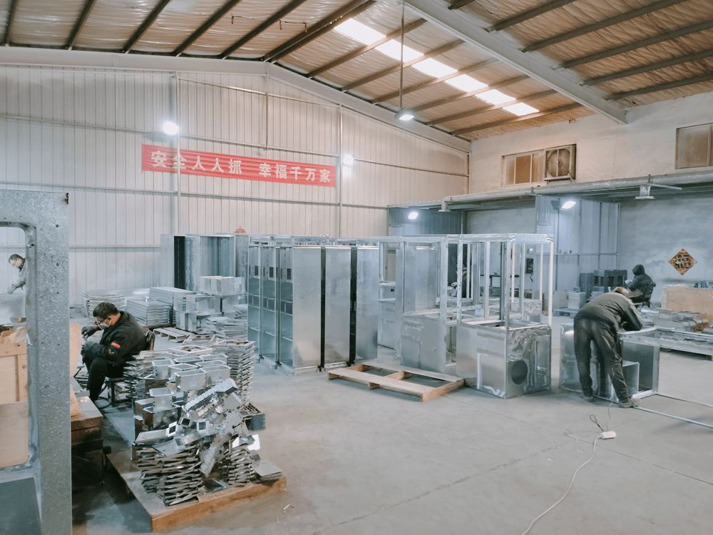 Welding station — technician assembling vending machine chassis components